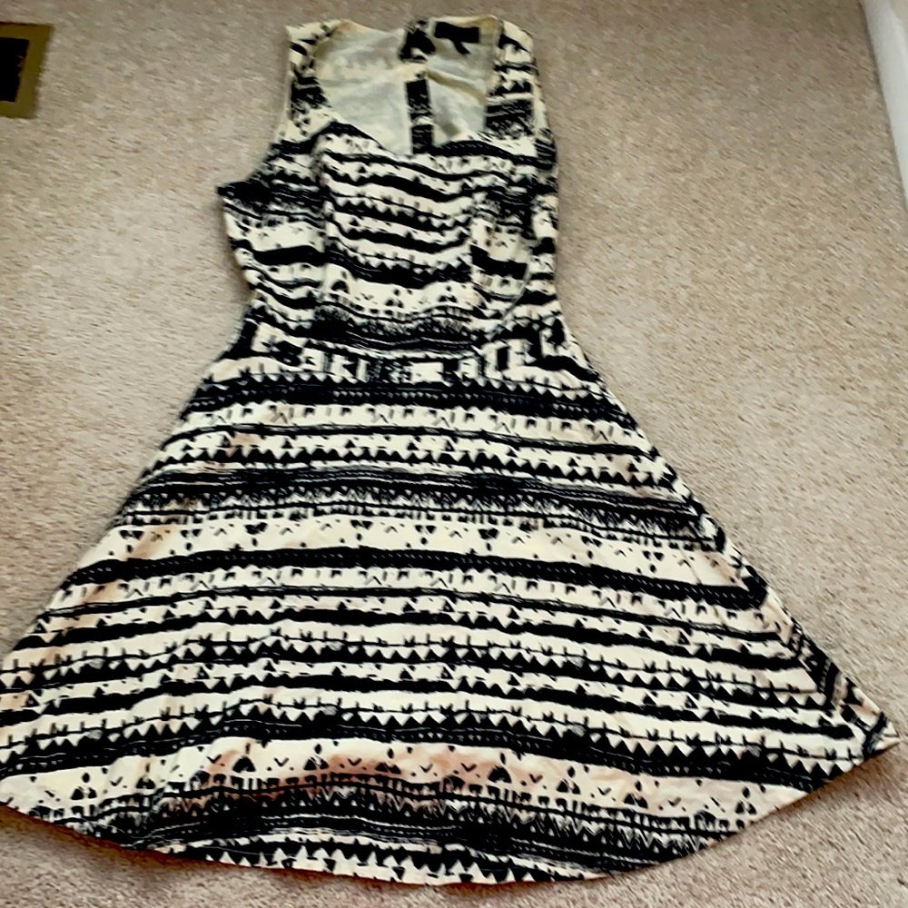 tan and black dress with cut out back.